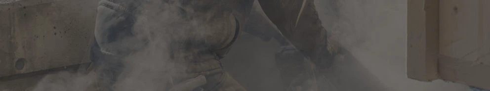 Arbeiter kniet und wirbelt Staub auf